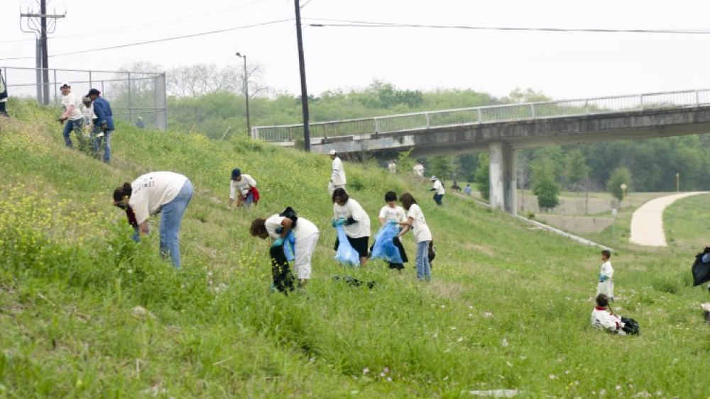 River Authority volunteers picking up trash along the San Antonio River.