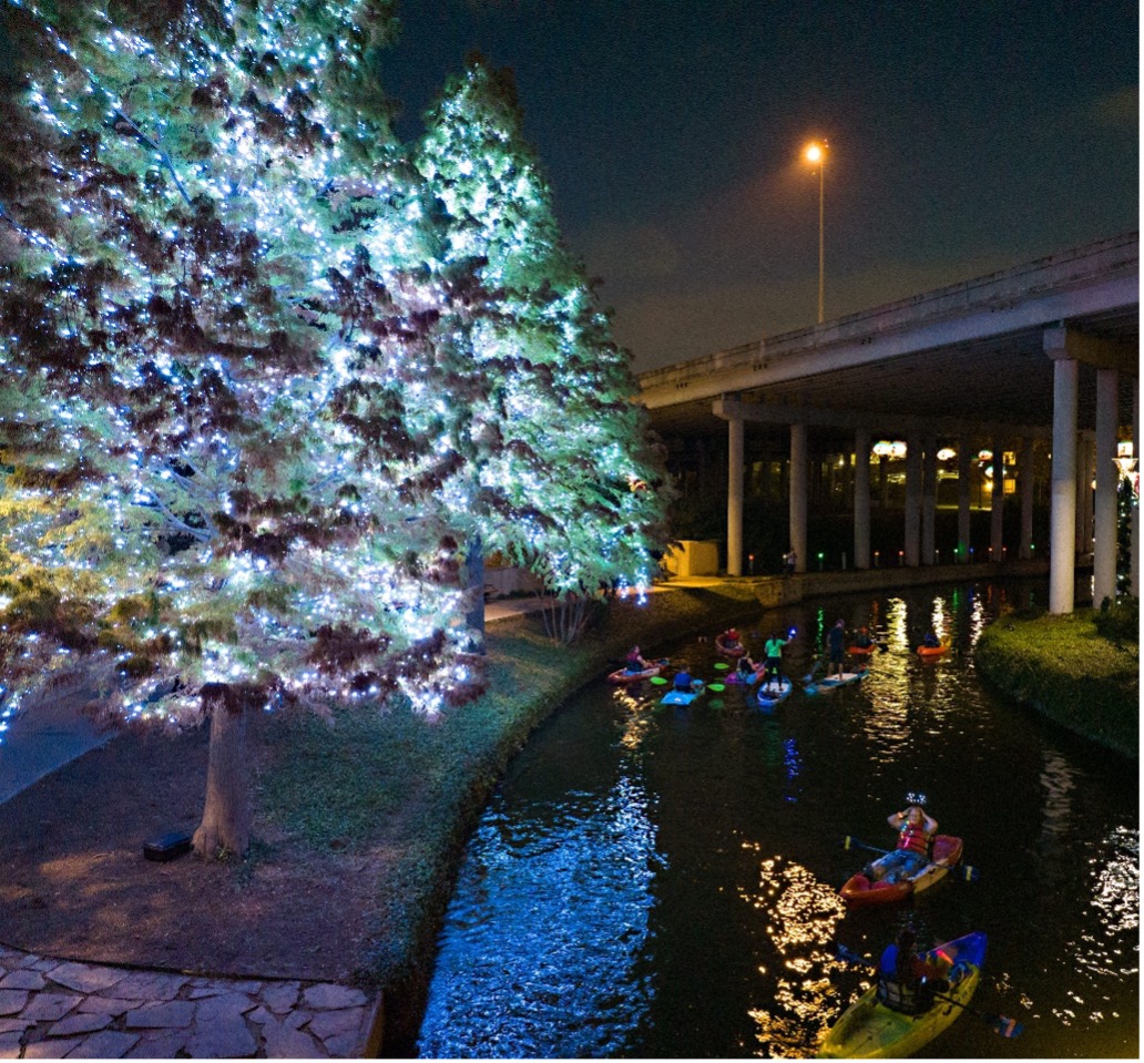 Nighttime Kayaking during a holiday event on the Museum Reach of the San Antonio River.
