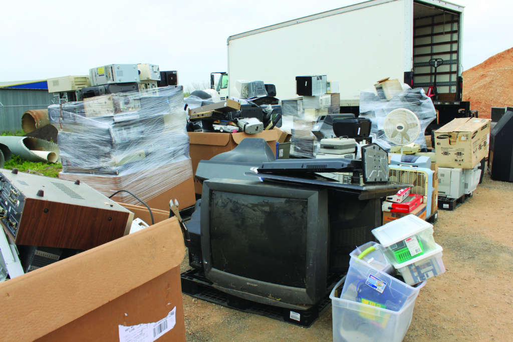 Mass Collection of Household Hazardous Waste items are piled around pickup van for disposal.
