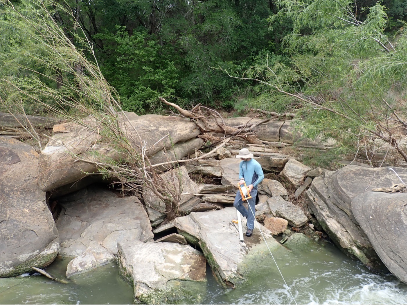 ESD team member Austin Davis collects data at Leon Creek (Site 14198).