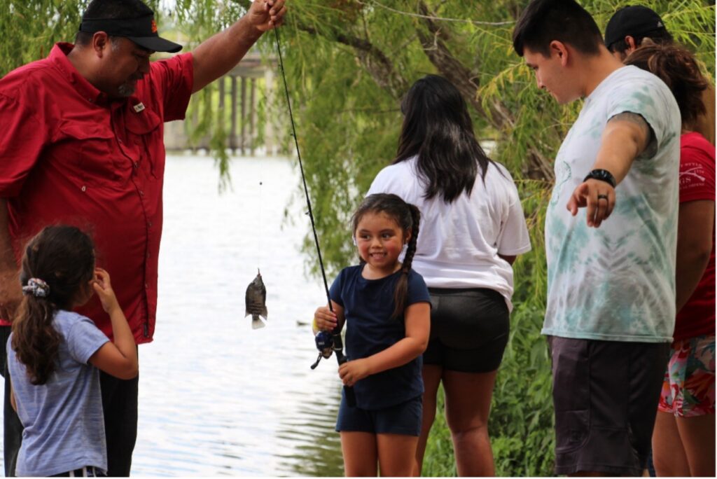 Girl smiles at her caught fish