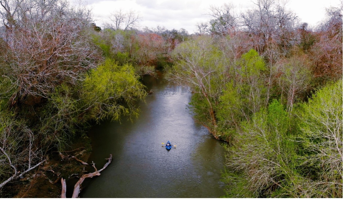 A Paddler coasts down the San Antonio River in Goliad County
