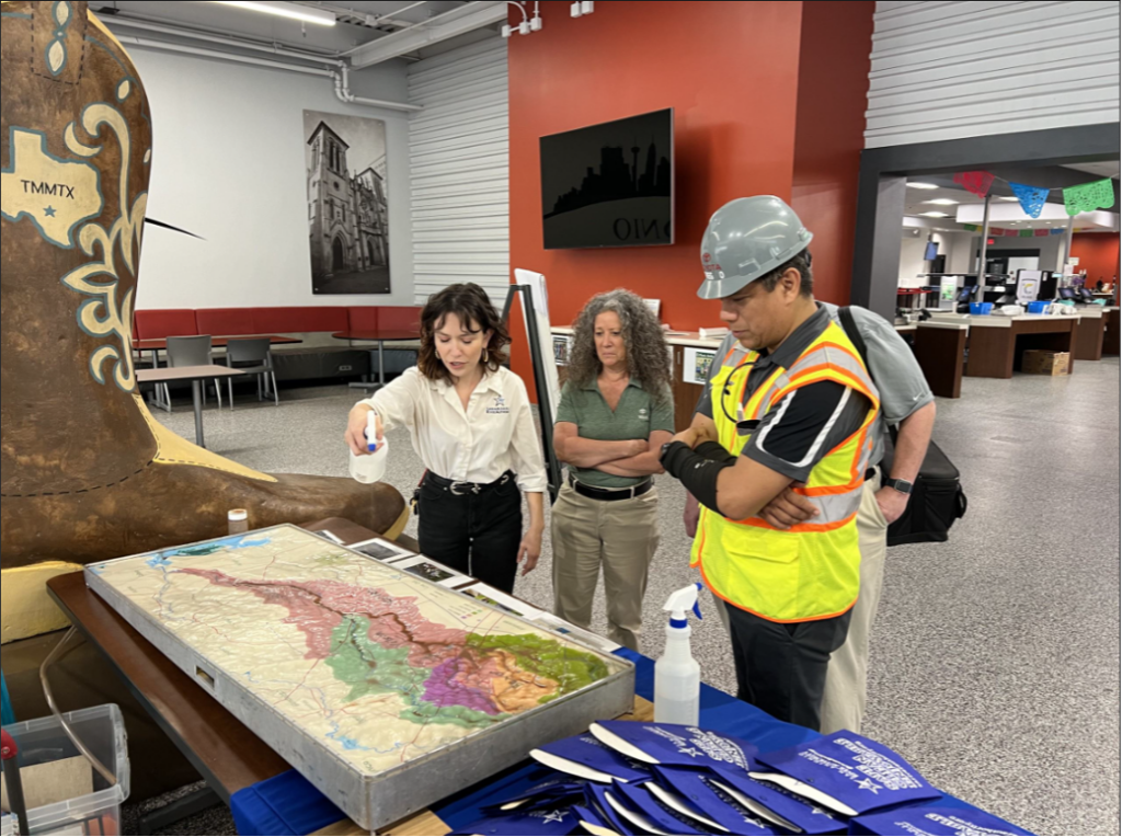 People gather around a watershed model