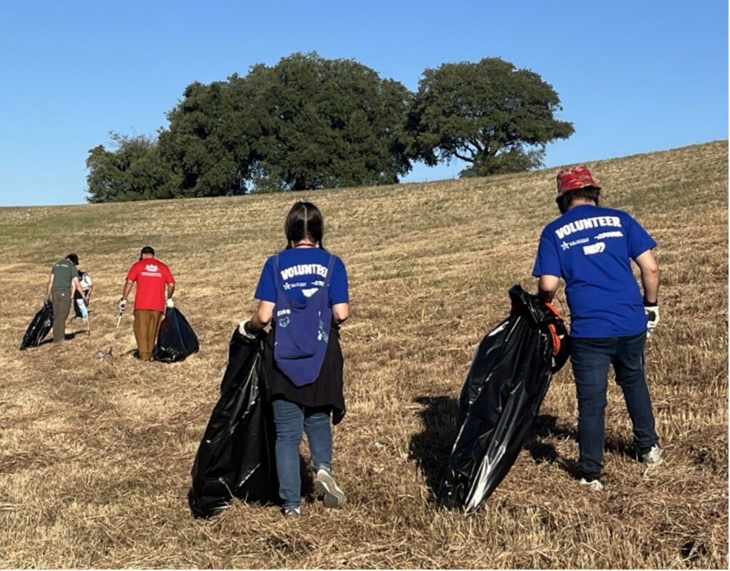 River Warriors collecting trash in a field