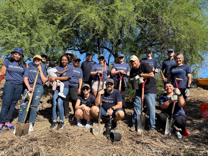 A group of volunteers stand together to pose for a picture