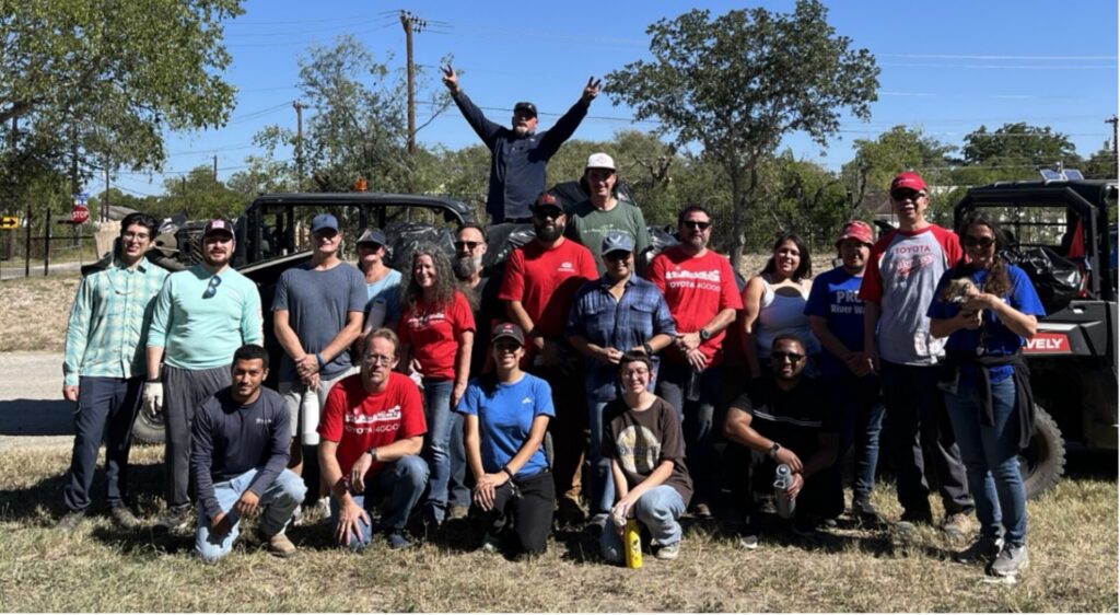 A group of people pose together after a successful cleanup event.