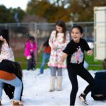 Children play together in the snow.