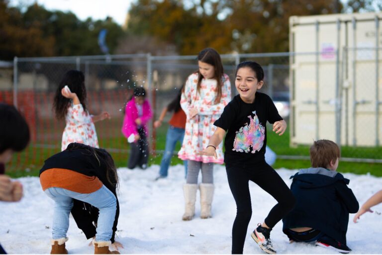 Children play together in the snow.