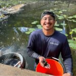 Scientist holds handfuls of mussels in his hands