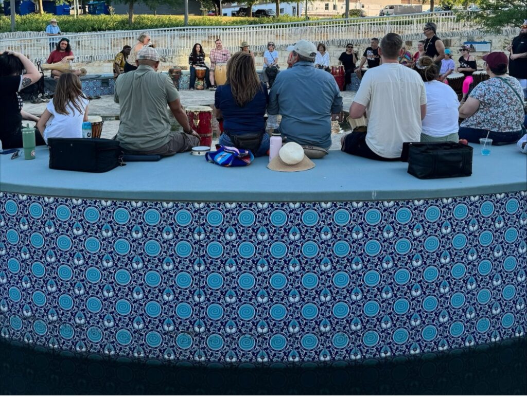 People sit on a bench with Menchaca Tiles