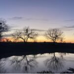 Sun sets along a pond in Karnes County