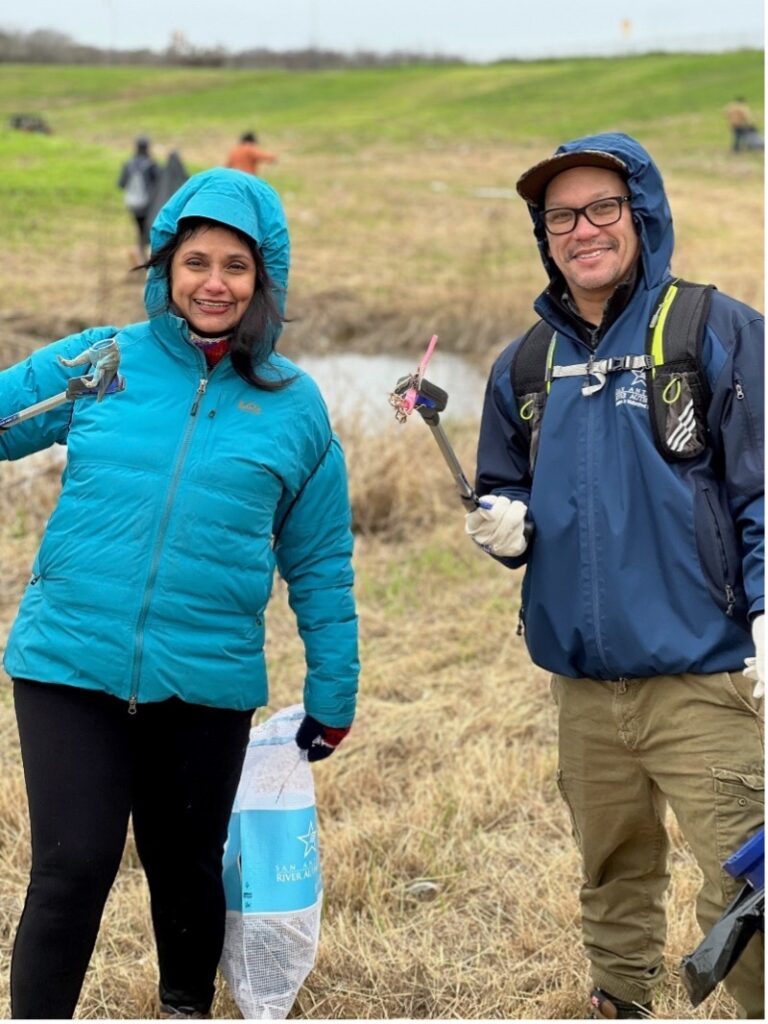 Two people stand together during clean up event