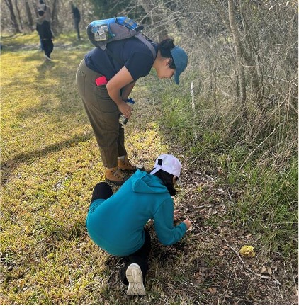 Two people make observations in the nature