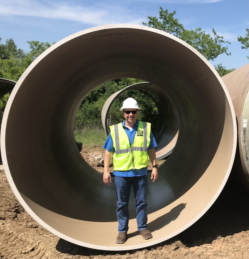 Steve Metzler stands inside one of the concrete pipes.